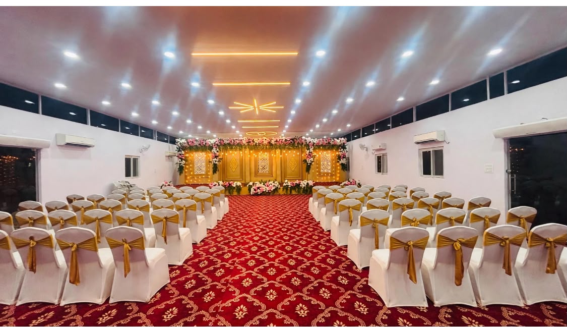 Seating and stage inside Ishaa Banquet Hall